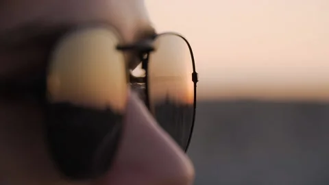Close up of a young man in sunglasses looking at the view at the sunset Stock Footage 142550052
