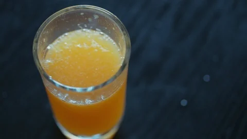 Close-up of young man  taking a glass of orange juice Video stock 119892385