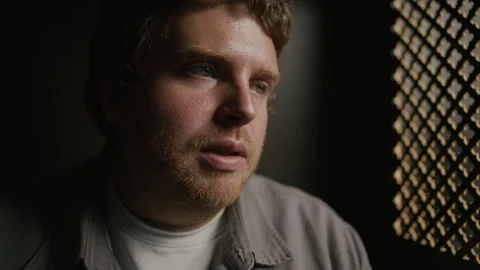 Close-Up of Young Man Talking Thoughtfully during Confession in Church Stock Footage 318340339