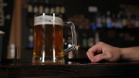 Close-up young man with tattoos drinking beer at bar or pub. Stock Footage 133169714