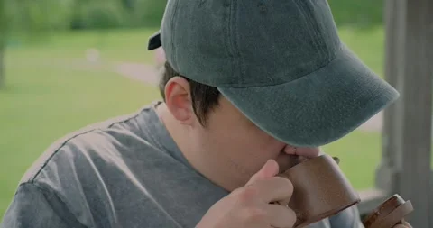 Close-up of a young man with tattoos smelling the aroma of fermented... Stock Footage 316915276