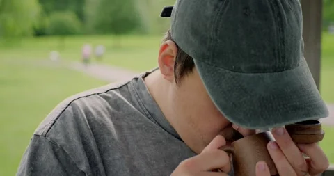 Close-up of a young man with tattoos smelling the aroma of... Stock Footage 316915408