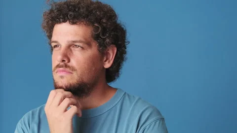 Close up, young man thinks over his problem, remembering something isolated on Stock Footage 247010052