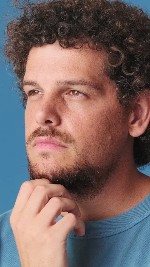 Close up, young man thinks over his problem, remembering something isolated on Vídeo Stock 250840637