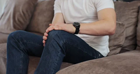 Close up of young man touching his knee feel pain and doing massage sitting on Stock Footage 269155190