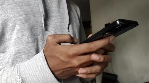 A Close-up of A Young Man Typing on His Phone Видео 332383388