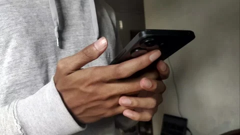 A Close-up of A Young Man Typing on His Phone Stock Footage 332383392