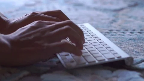 Close-up of a young man typing on a laptop keyboard Stock Footage 73100041