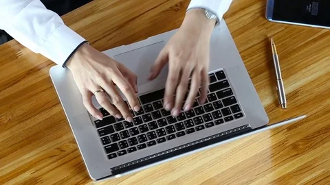 Close-up of a young man typing on a laptop keyboard Stock Footage 73614679