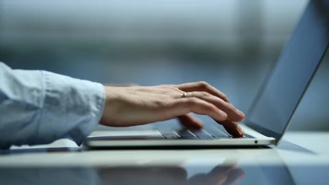 Close-up of a young man typing on a laptop sipping an espresso at the office Stock Footage