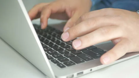 Close-up of a young man typing on a laptop keyboard Stock Footage 92335682