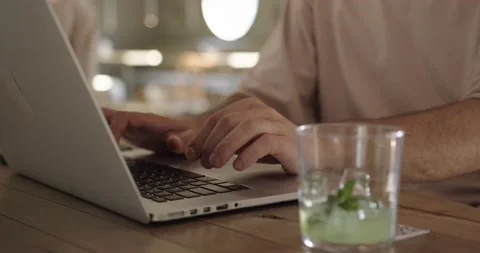 Close up of young man typing on laptop at cafe Stock Footage 159082988