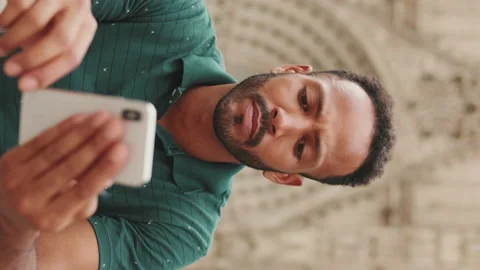 Close up, young man uses cellphone while sitting on the steps of the Sagrada Stock Footage 227096489