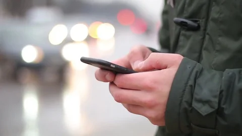 Close up of a young man using his smartphone on the street. Stock Footage 85412456