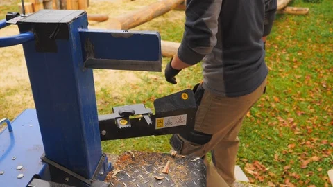 Close up of young man using hydraulic press machine for cutting wood 動画素材 96004977