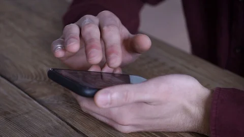 Close-up Young man using mobile smart phone web browsing internet at home Stock Footage 105321832