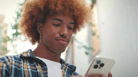 Close up, young man using mobile phone outside Stock Footage 253937438