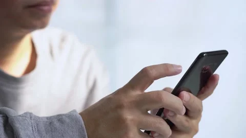 Close-up young man using smartphone browsing social network messages at home. Stock Footage 145531929