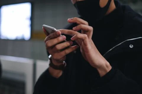 Close up young man using smartphone in subway station Fotos Stock