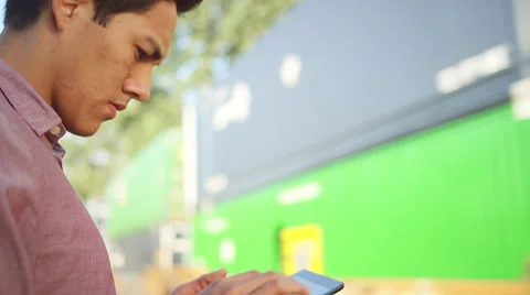Close up of a young man using a tablet as a train goes by Видео 57503571