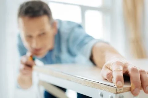Close up of young man using a tape measure Stock Photos