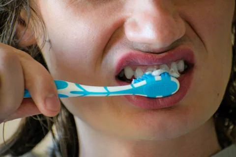 Close-up of a young man while brushing his teeth, personal hygiene. Young man Stock Photos