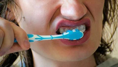 Close-up of a young man while brushing his teeth, personal hygiene. Young man Stock Photos