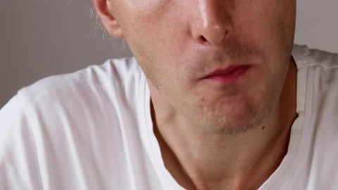 Close-up of young man in white t-shirt eating pasta with visible mouth move.. Stock Footage 319826500