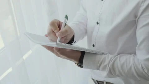 Close up of Young man worker taking notes standing in office. Stock Footage 139507485