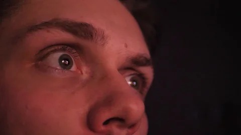 Close-up of a young man's eyes looking at screen in a deep night. Young man Video stock 128435165