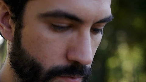 Close up on young man's face raising his head and looking up Stock Footage 136546101