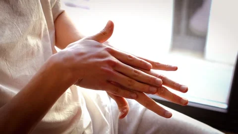 Close-up of a young man's hand applying moisturizing cream to his hand Stock Footage 304198449