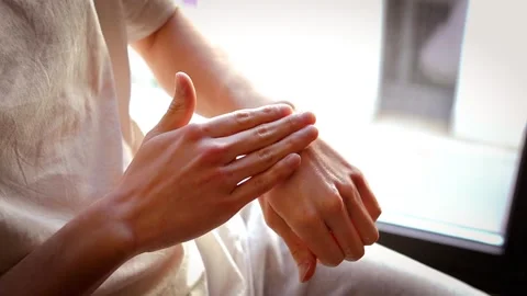 Close-up of a young man's hand applying moisturizing cream to his hand Stock Footage 304198450