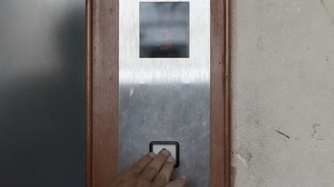 Close up young man's hand pressed the button for the elevator in office or ho Stock Footage 143894616