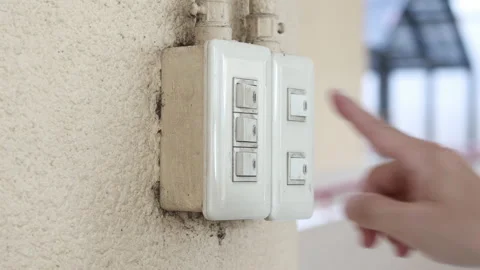 Close up young man's hand pressed the button to turn on the light switch, Ope Stock Footage 143894628