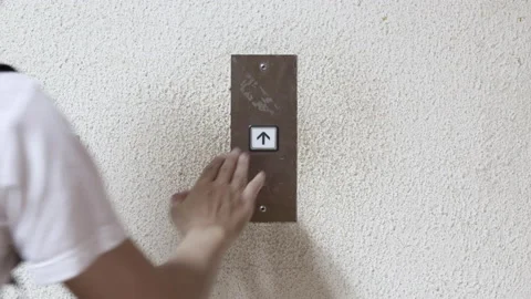 Close up young man's hand pressed the button for the elevator in office or ho Stock Footage 143894720