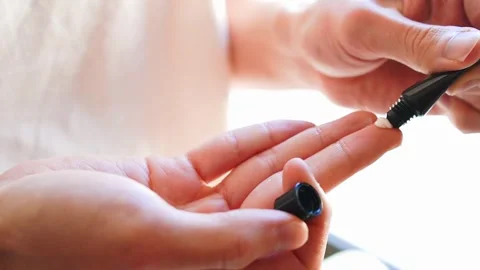 Close up of a young man’s hands applying beauty cream onto his fingertip Stock Footage 302026733