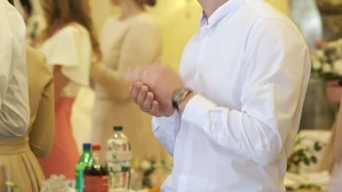 Close-up of a young man's hands clapping at a celebration. Stock Footage 274061686