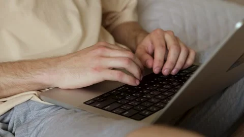 Close-up of a young man's hands working on a laptop. Stock Footage 279590696