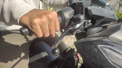 A Close-up of A Young Man’s Right Hand Gripping The Motorcycle’s Throttle Stock Footage 332383391