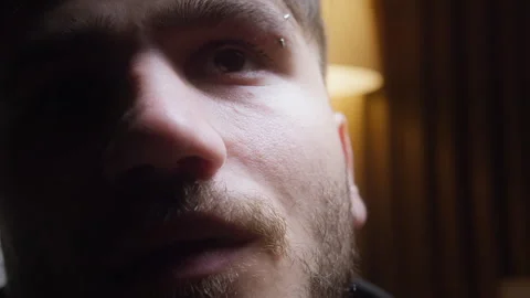 Close-up of a young mans thoughtful expression in moody lighting, highlight.. Stock Footage 307245208