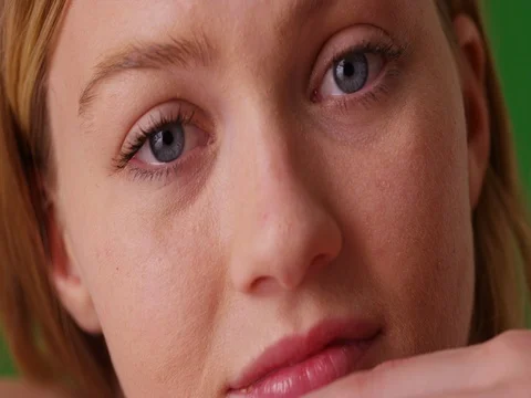 Close up of young millennial Caucasian woman looking into camera on green screen Stock Footage
