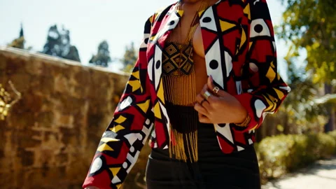 Close up of a young model's torso walking in a park wearing South African style Stock-Footage 183988794