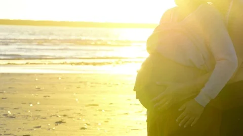 Close up of a young mother to be rubbing her pregnant abdomen Stock Footage 76735305