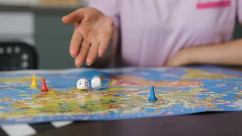 Close-up of young mother rolling dice indoors Stock Footage 279098933