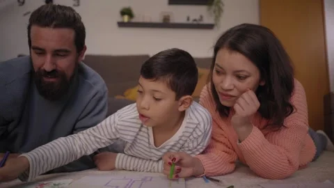 Close up young multiracial parents helping only child with homework at home Stock Footage 246645063