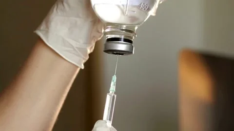 Close up young nurse preparing injection with syringe in hospital a medical Stock-Footage 336587209