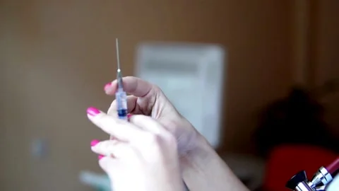 Close up young nurse preparing injection with syringe in hospital a medical Stock-Footage 336587250