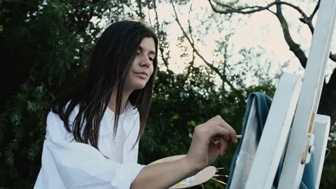 Close up of an young painter that paints on the textile. Stock Footage 138461736