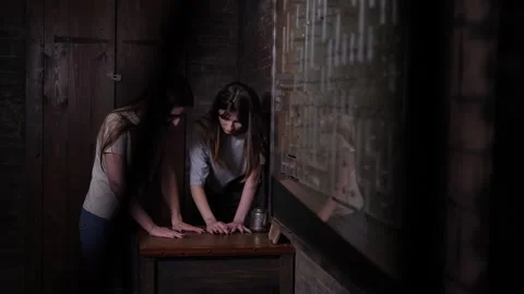 Close-up of young people spinning discs on a wooden board in a dark quest room. Stock Footage 310655647